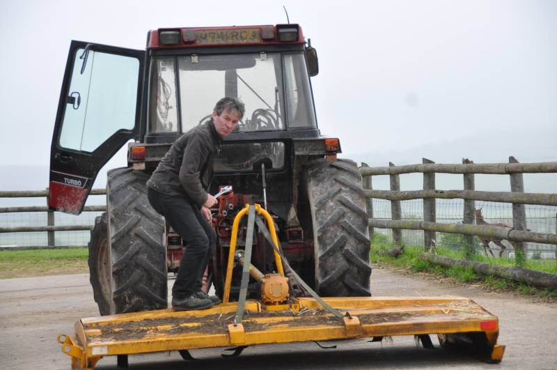 Higgs preparing his topper to cut the grass on the schooling ground Higgs preparing his topper to cut the grass on the schooling ground